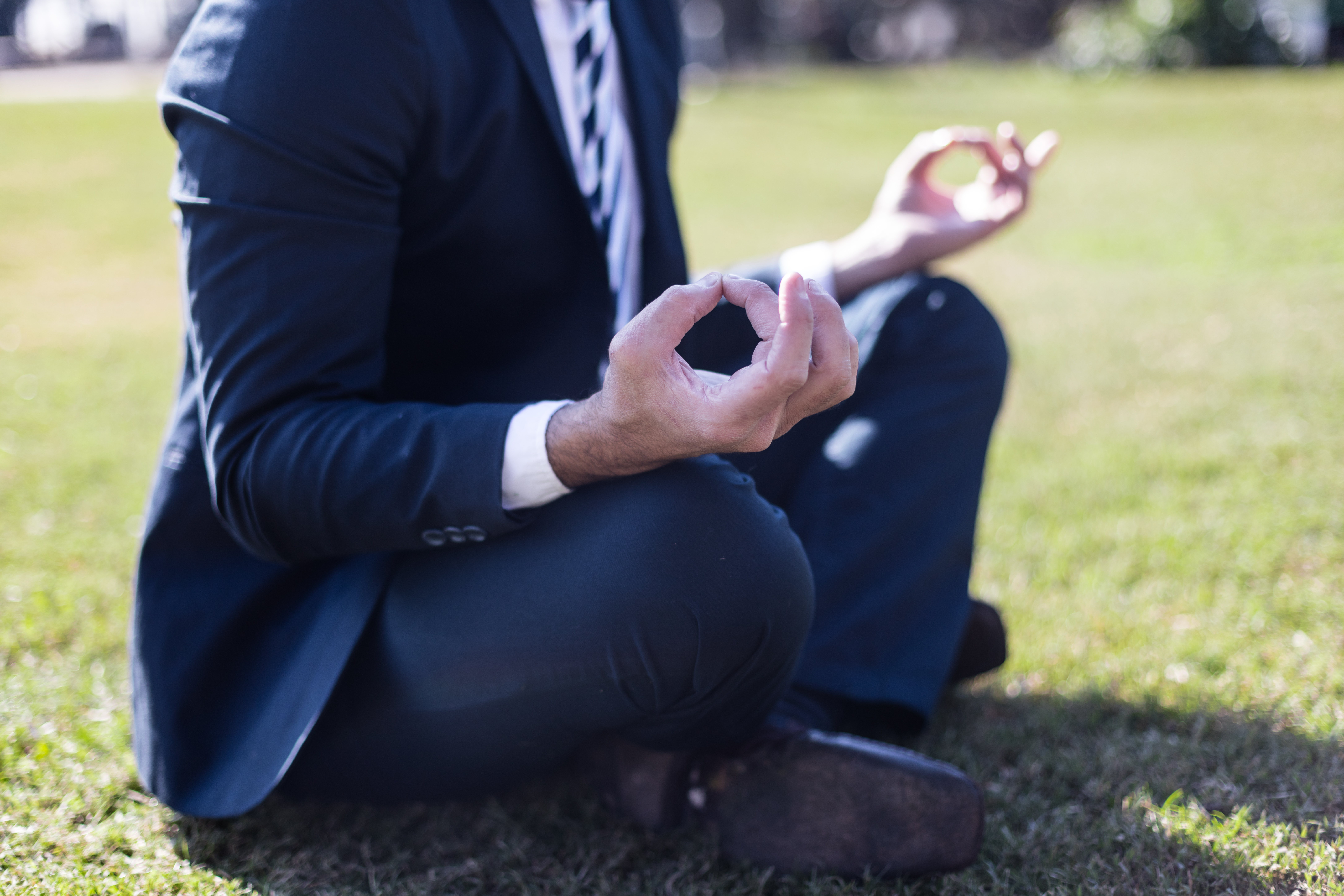 close-up-relaxed-worker-lotus-position