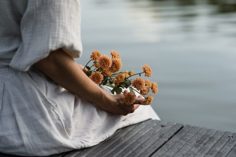 side-view-woman-holding-beautiful-flowers